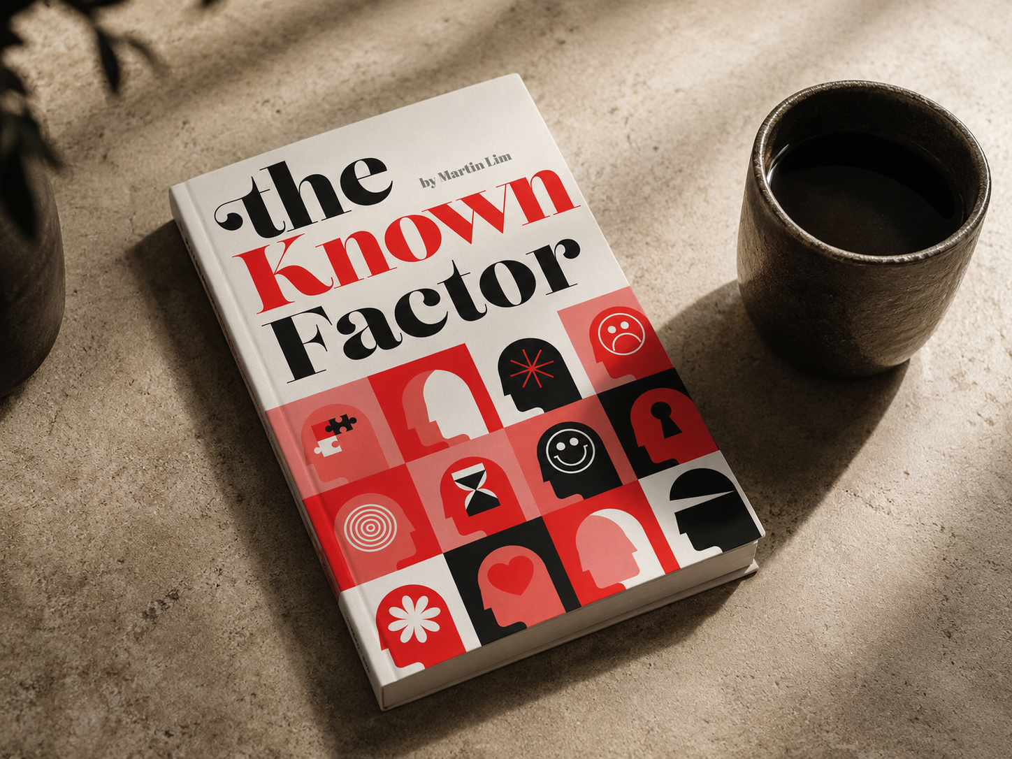 The Known Factor book on a table beside a cup of coffee
